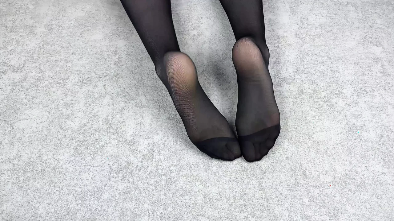 Mistress caresses her feet in black nylon pantyhose