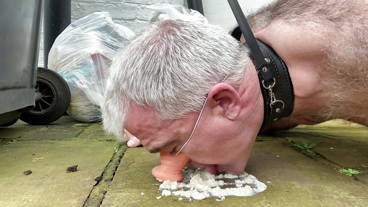 Humiliated gay pig slave eats food off the filthy ground