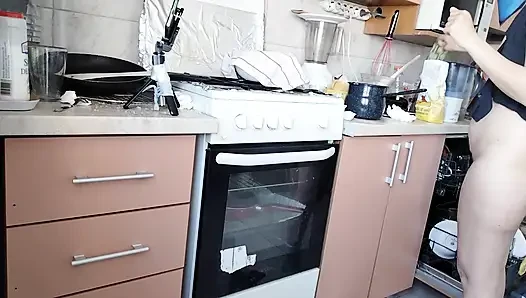 Sexy wife prepares lunch naked in the kitchen.