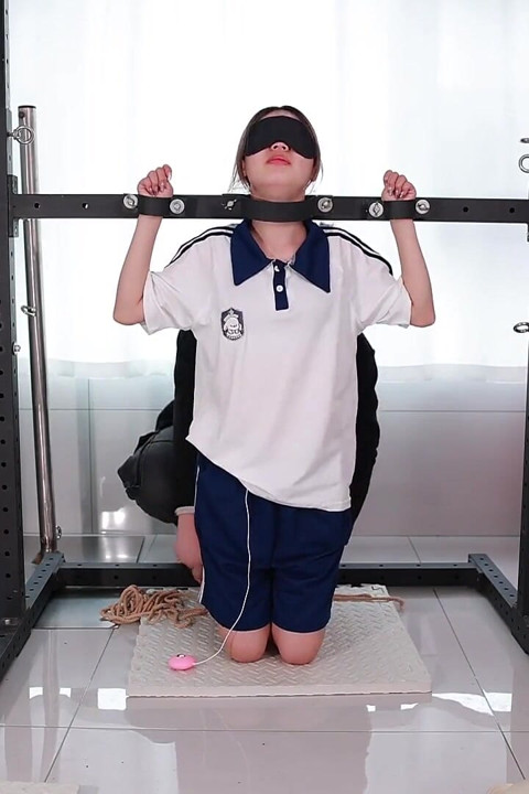 A Girl with a Metal Gag in Place, Playing with Her Tongue