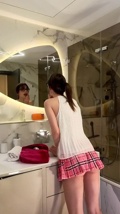 Long legs nerdy college girl with a short skirt and panties shows off in the bathroom | Clip 1