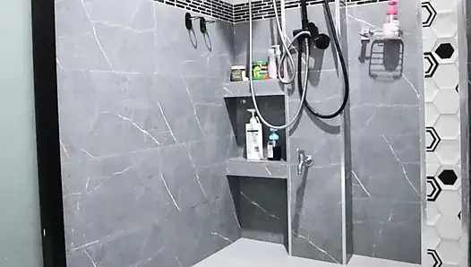 A Thai woman is taking a shower, revealing her pink nipples and smooth, soft vagina while applying body lotion.  Real Thai Solo