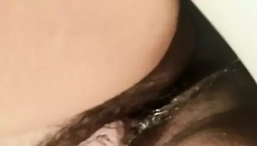 Girl with big hairy pussy lips is pissing