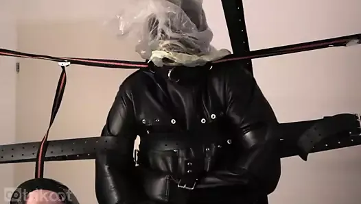 Standing bondage in leather straitjacket