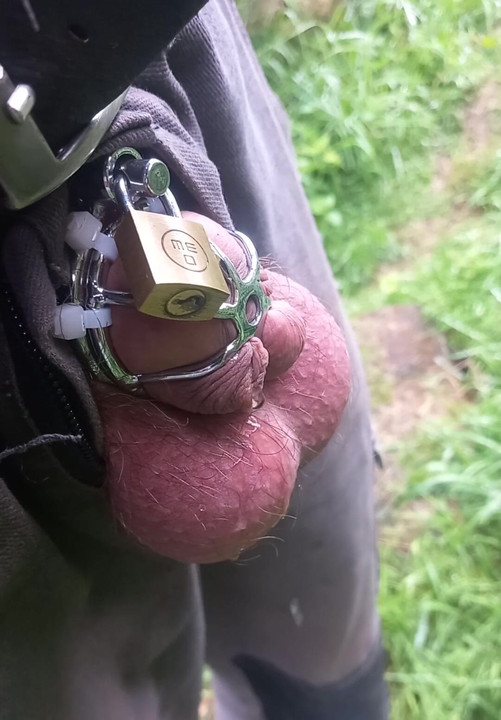 Cuckold with helpless small cock and chastity cage pisses outdoors