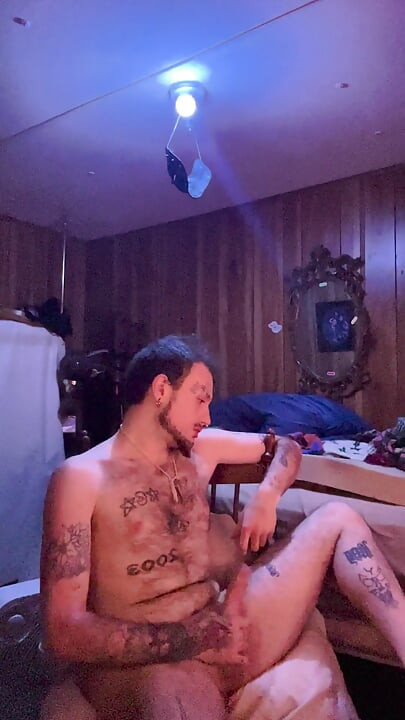 Tattoo stud playing with his cock