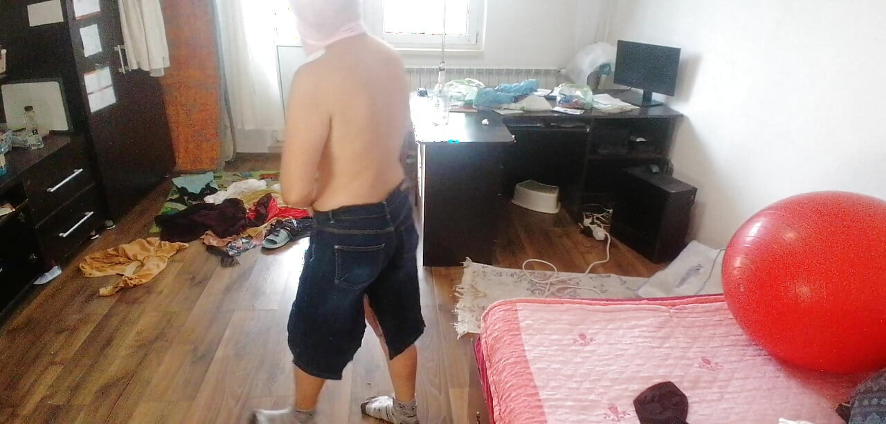 Amateur woman has fun trying on clothes and cutting them.