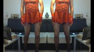 maninboots wearing red latex dress and showing buttplug