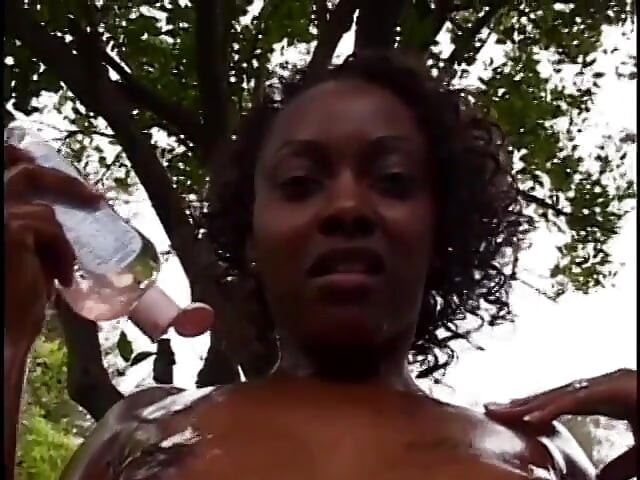Ebony babe and black stud have slippery fuck session on the grass