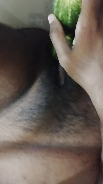 Busty bitch playing with herself and fucking herself with a cucumber