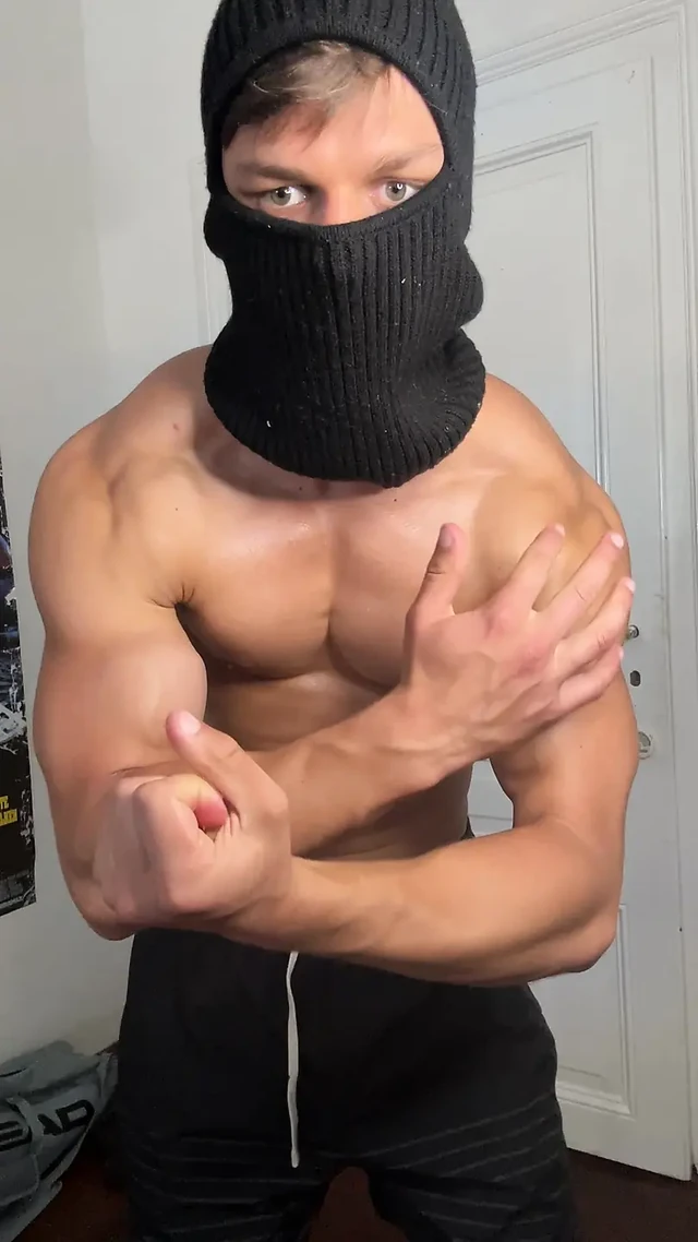 Masked hunk showing off his muscles