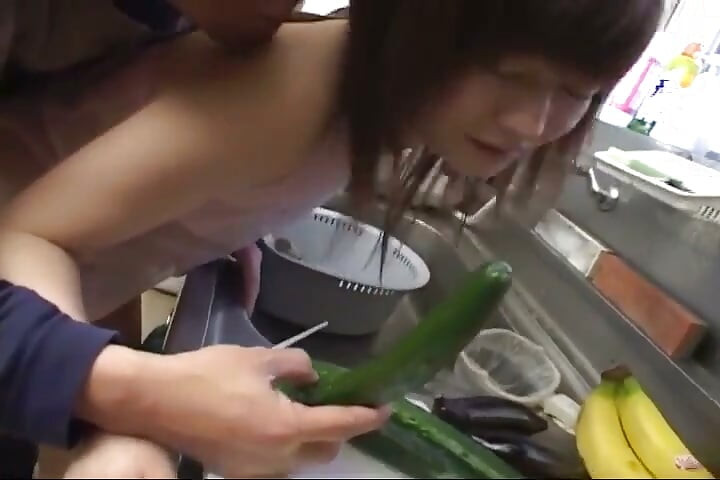 Insatiable Young Wife Drenches Cucumber Deep in Kitchen Sink