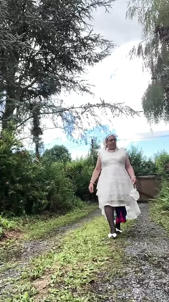 In an outfit with a long white dress for an evening.