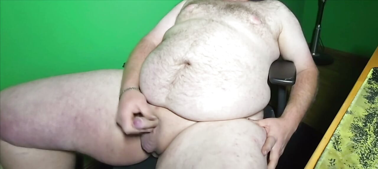 A fat boy with a small dick is masturbating.