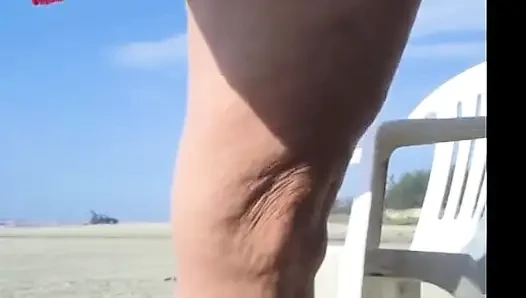 Hot crown sunbathing on the beach in transparent micro bikini