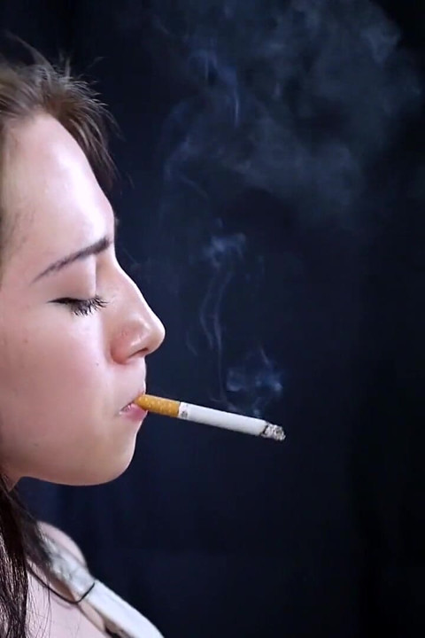 Brunette Teen Is Smoking White 100mm Cigarette
