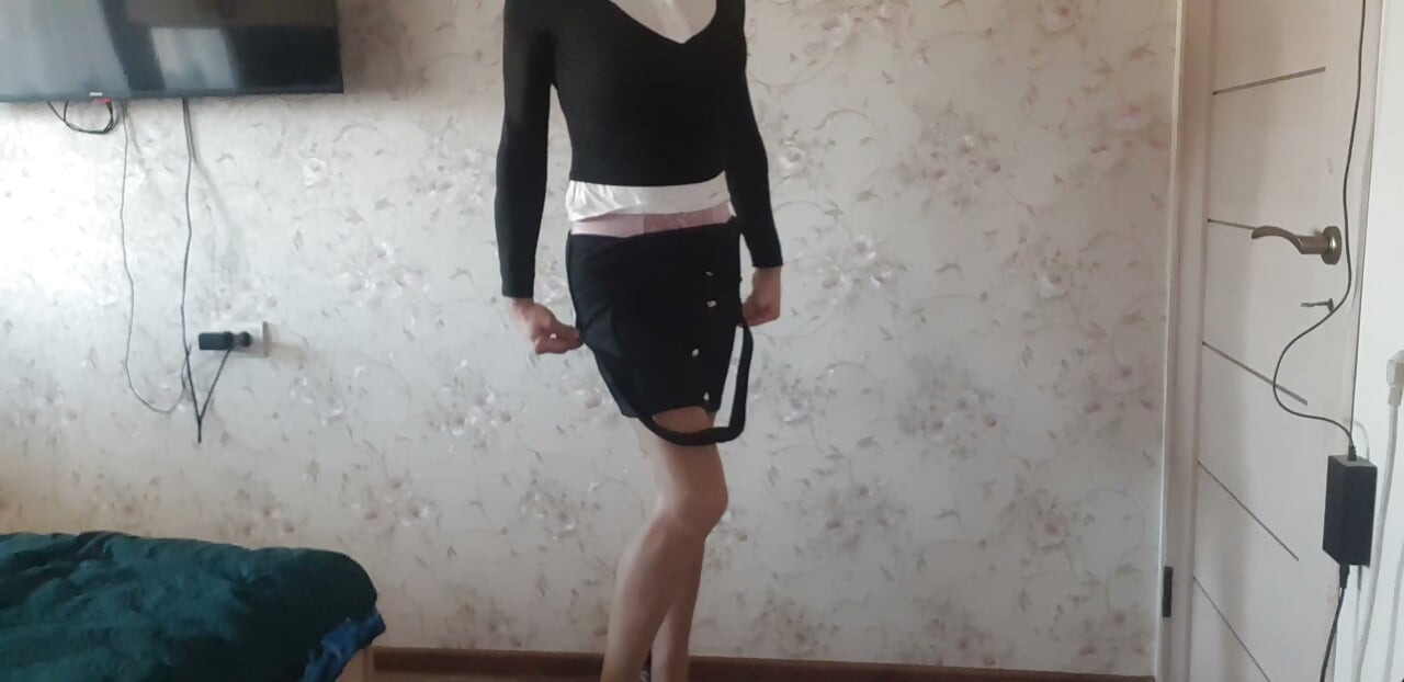 in a business suit, with a pink bodysuit underneath