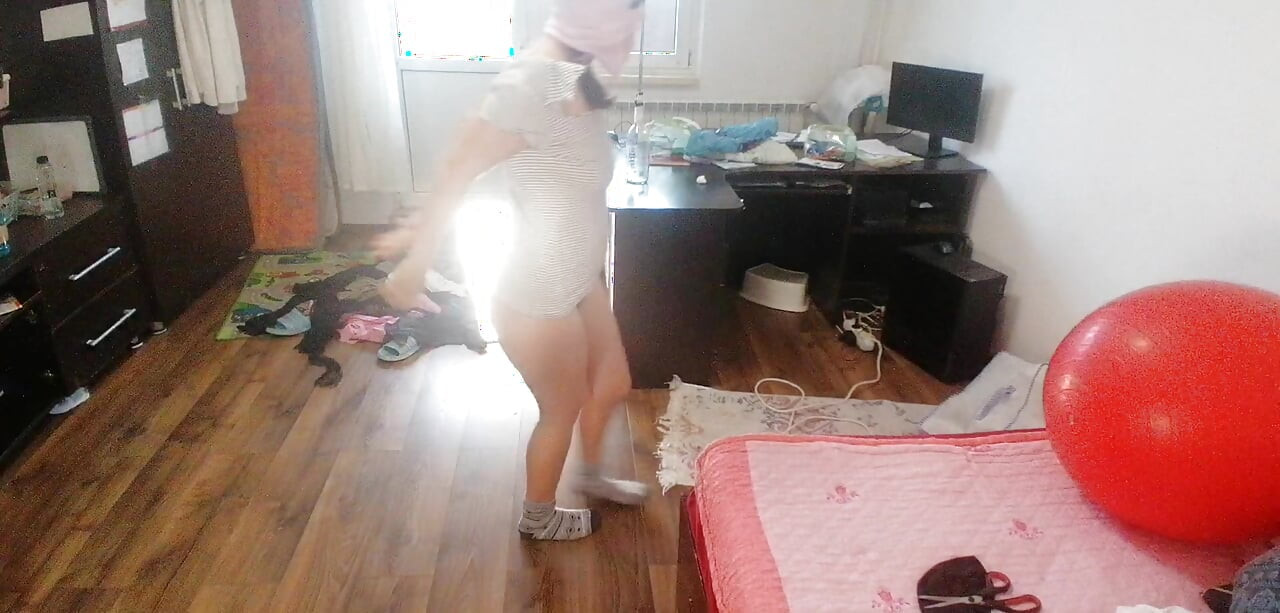Amateur woman has fun trying on clothes and cutting them.