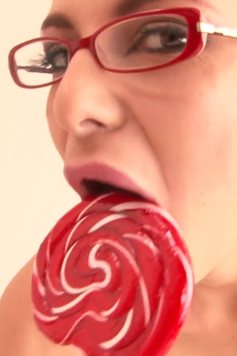 Cute brunette in red high heels showing her small tits on the bed