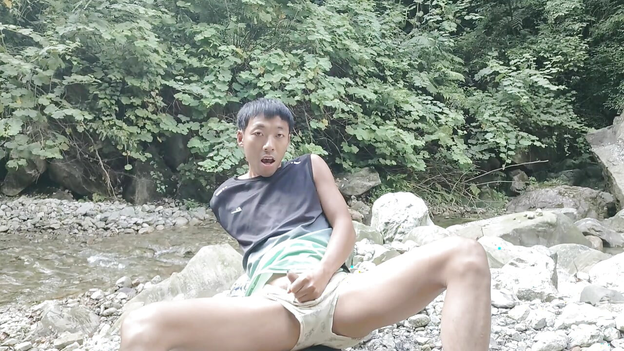 A wild boy masturbates, moaning and ejaculating by a stream in the deep mountains, and then eats his own semen