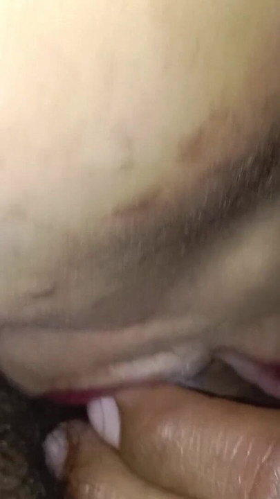 A village woman is enjoying licking her husband's penis, with a close-up view of her face. | Clip 1