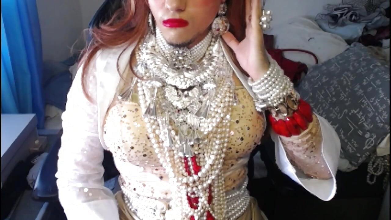 Crossdresser relaxing in pearls and heels