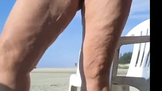 Hot crown sunbathing on the beach in transparent micro bikini