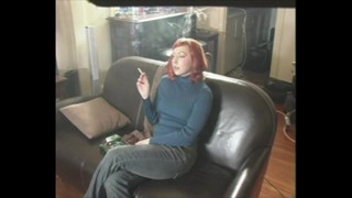 Sexy Redhead On Leather Couch Smoking A Cigarette