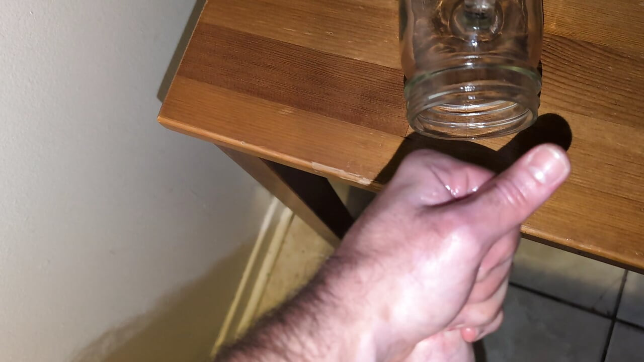 Fat man jerking his hard cock and cumming in a glass