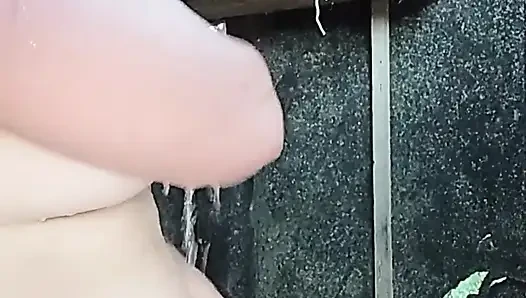 I'm watching a curvy girl wash herself in the street.