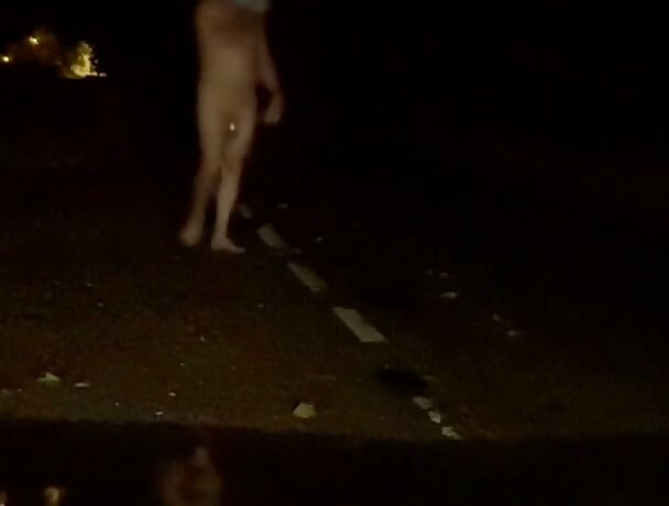 Naked in road and hiding the wrong side of road from safety when car passed