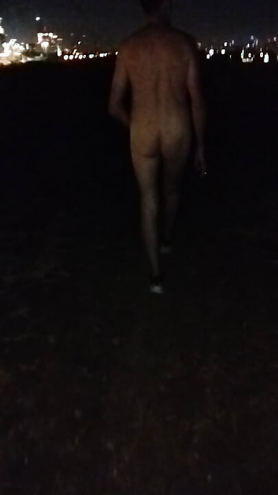 Naked walking on the hill along highway