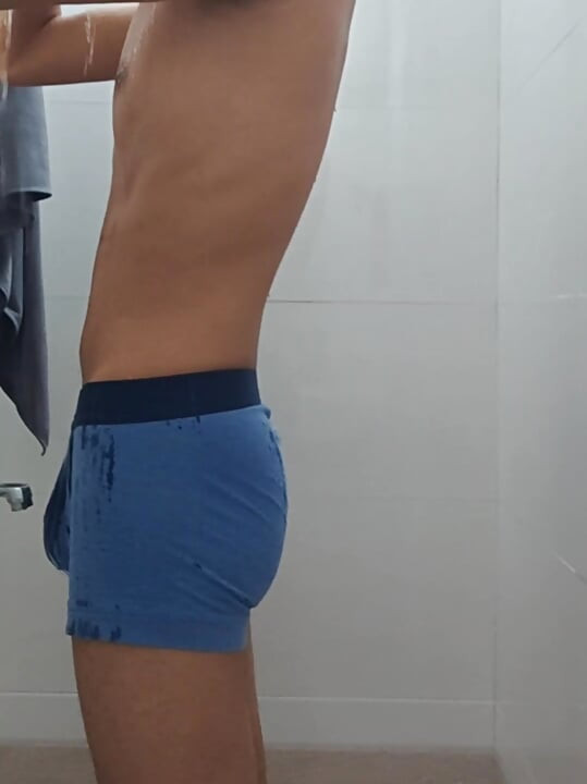 Teen indian boy taking shower