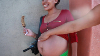 pregnant street-Big belly eating a chocolate covered banana