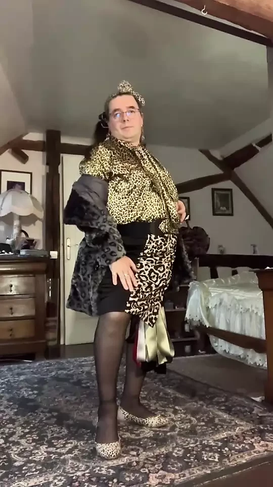 In skirt outfit, blouse and tie, leopard lavaliere with a coat