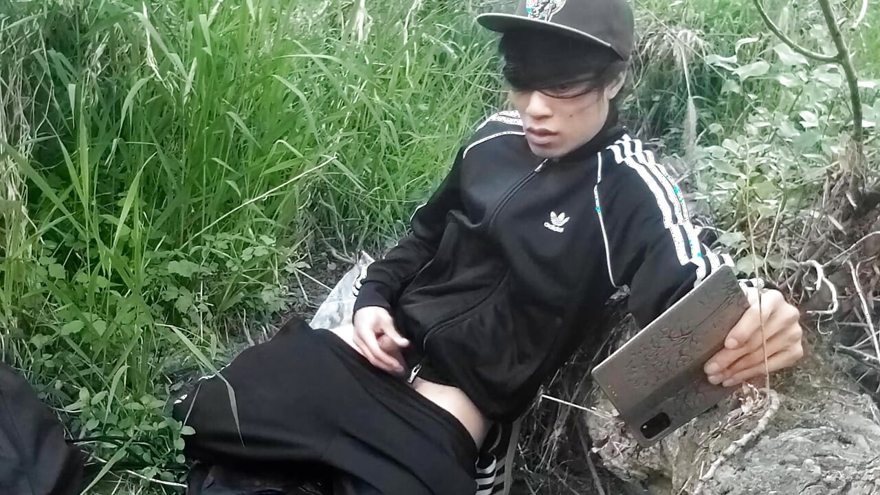 Cute Asian gay twink in a black-and-white adidas tracksuit and Campus sneakers masturbates and cums outdoors
