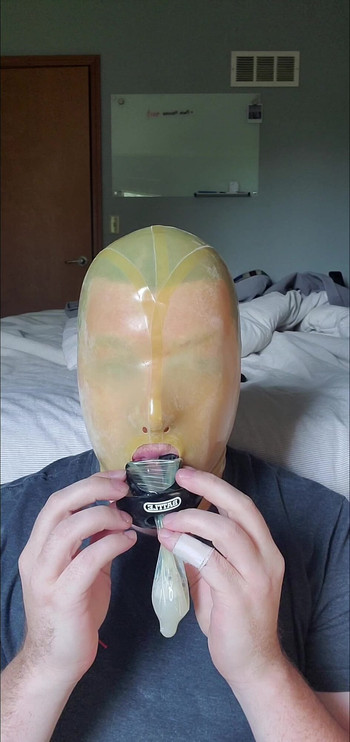 Latex Hooded Slut Swallows Load from Condom