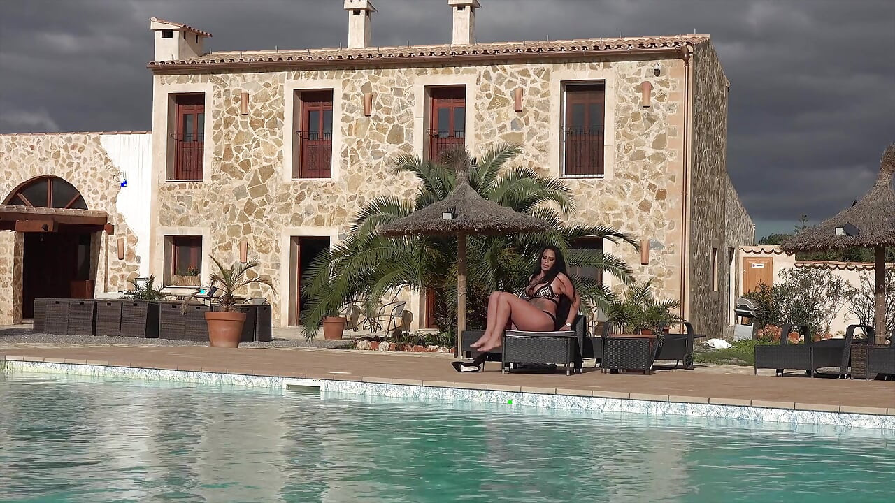 Hot Ilona Lies by the Pool and Rubs Her Pussy and Dildo with Oil