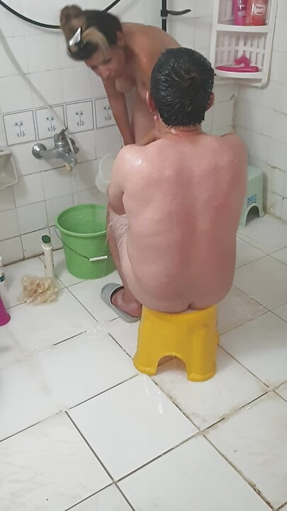 Old man bathing with his young girlfriend, Turkish couple in their natural home life.