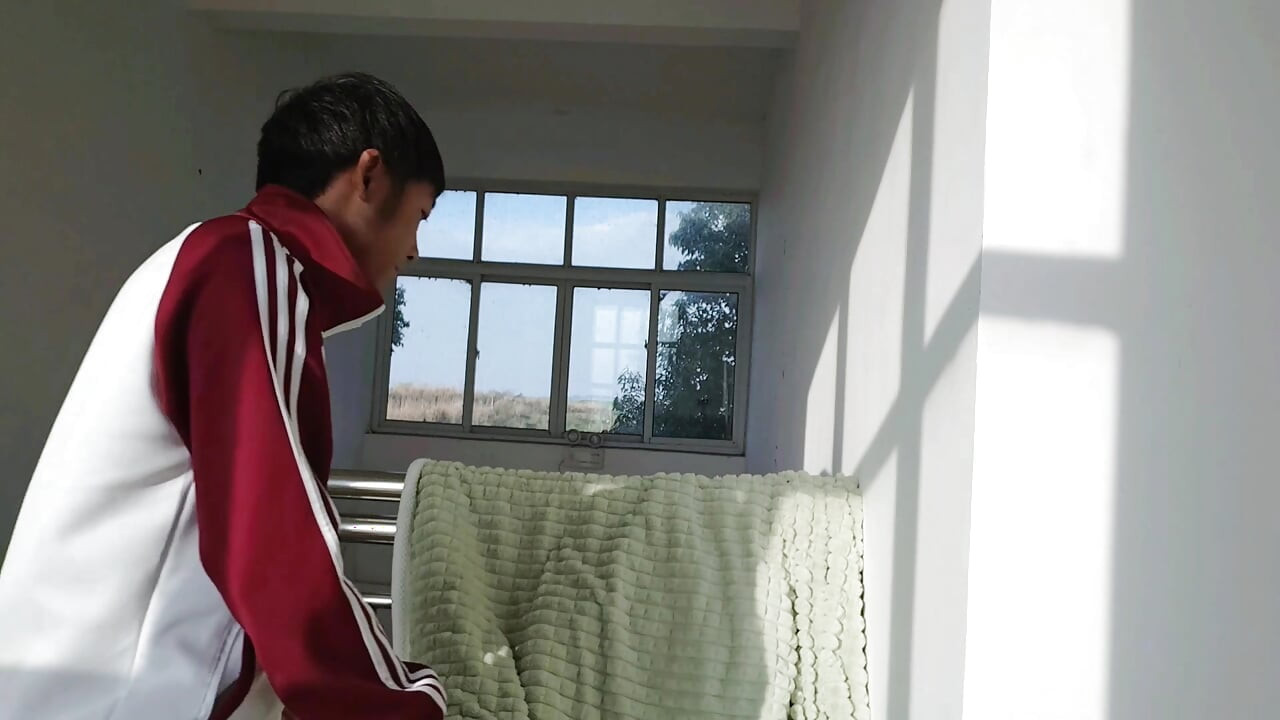 An Asian boy masturbates, moaning and ejaculating while sunbathing in a school corridor