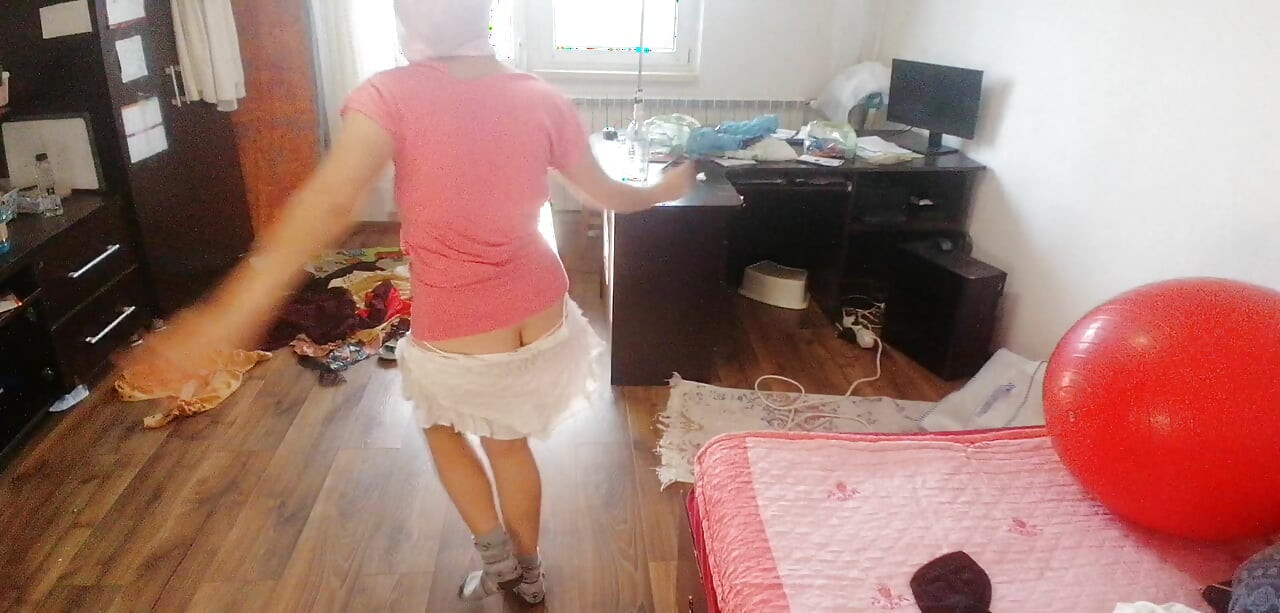 Amateur woman has fun trying on clothes and cutting them.