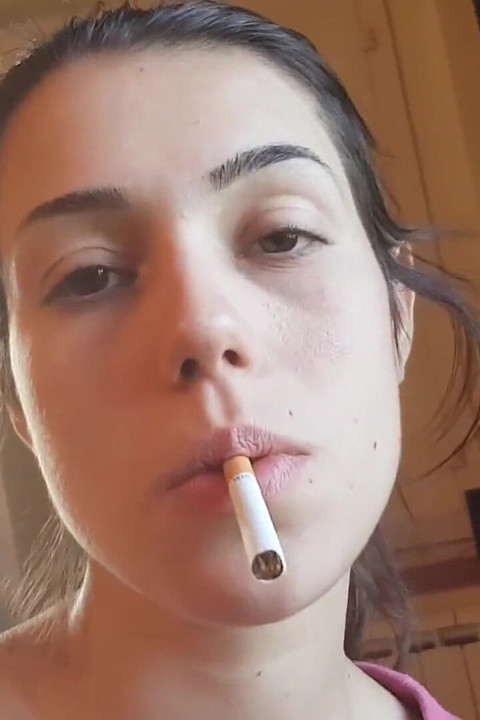 Tempting Italian girl smokes a cigar in a close up video