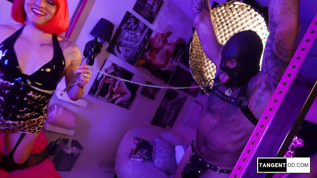 TANGENTOD Two Women in Crimson Latex Tease and Torment Masked Man with Crop and Heels
