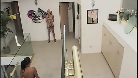 Two guys wearing masks get their large cocks sucked by a hot chick in latex gear