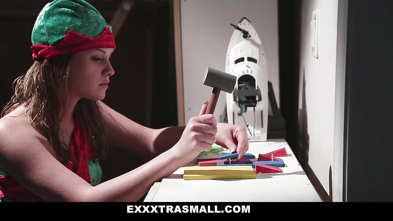 Tiny elf Lizzie Bel working extra hours for Santa in his bedroom