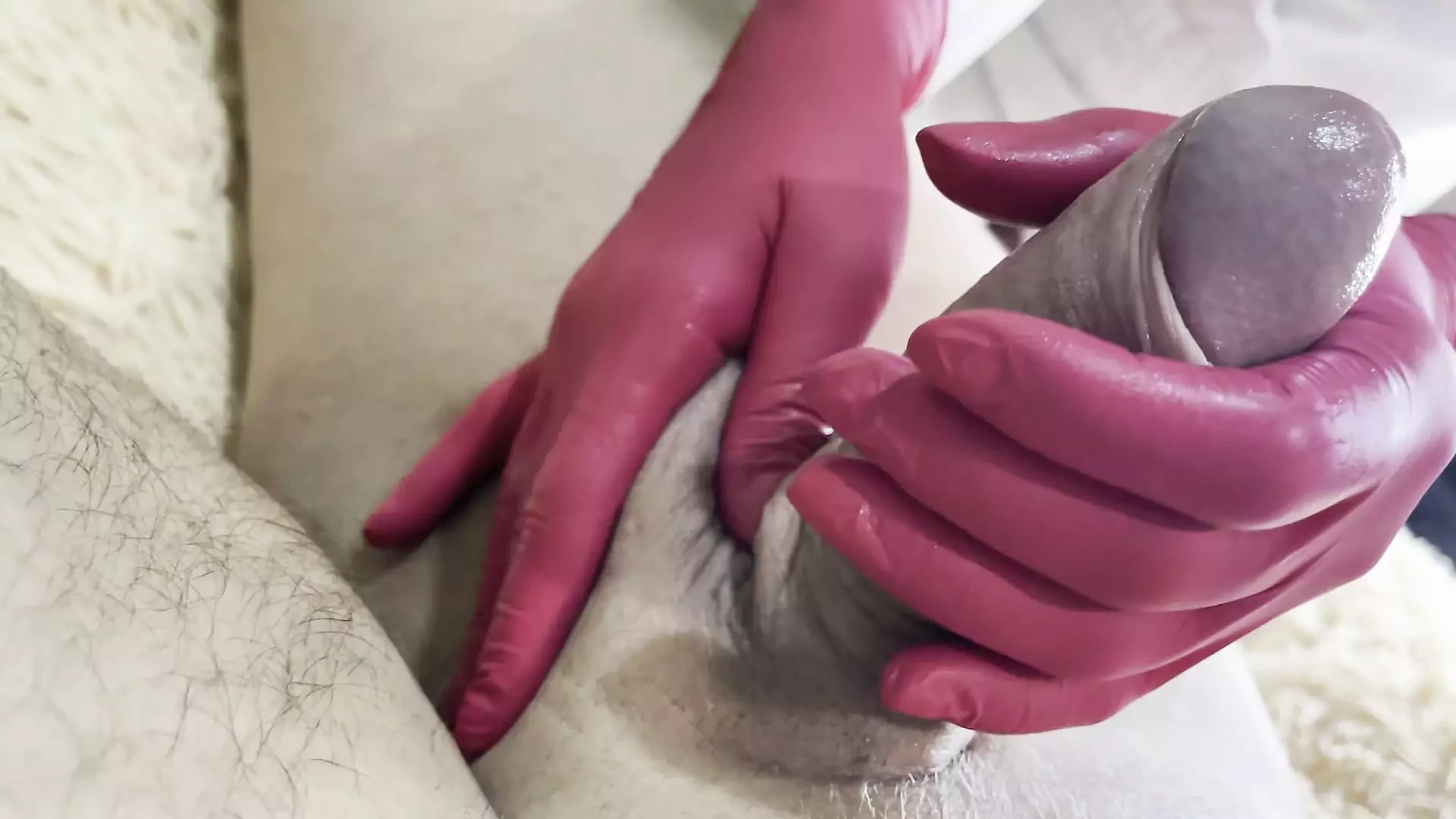 Horny milf jerks a thick dick with gloves on
