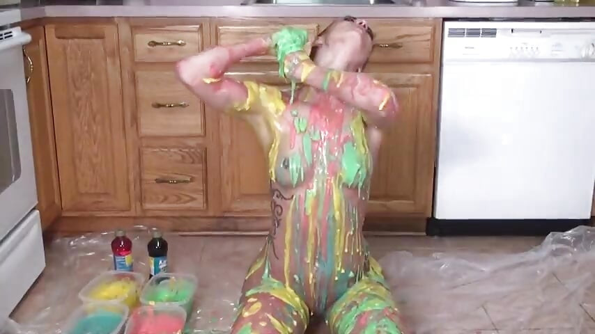 Hot girl puts colors  all on her tits and her pussy in the kitchen