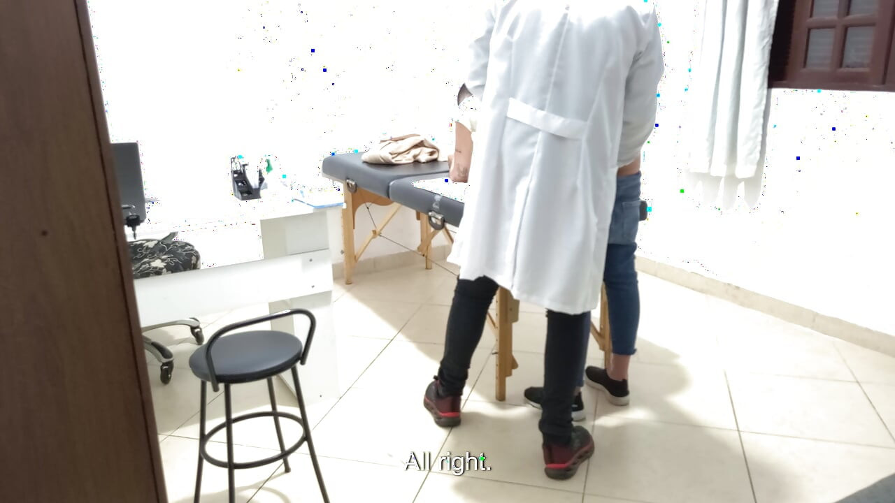 Proctologist performs anal exam on constipated patient.