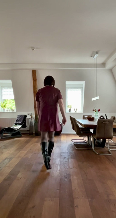 Nicolette in a sexy leather dress and platform high-heel boots