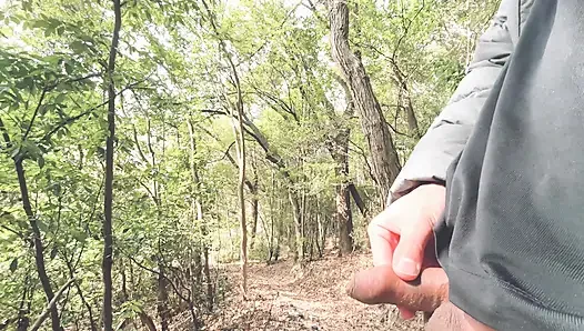 A boy with a small foreskin pees a huge stream outdoors